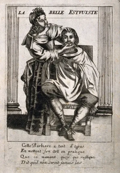 A female barber preparing to shave a man