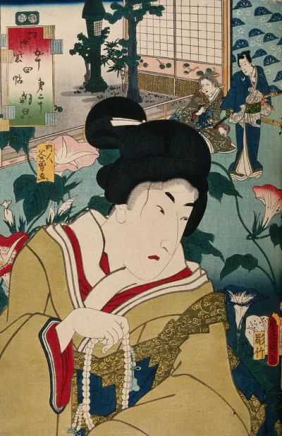 A female role actor with strong male features, holding prayer beads