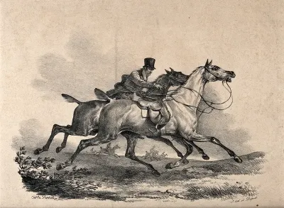 A gentleman on a horse is trying to grasp the reins of another horse while both horses are galloping