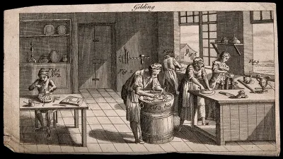 A gilder's workshop: people gilding articles with gold leaf