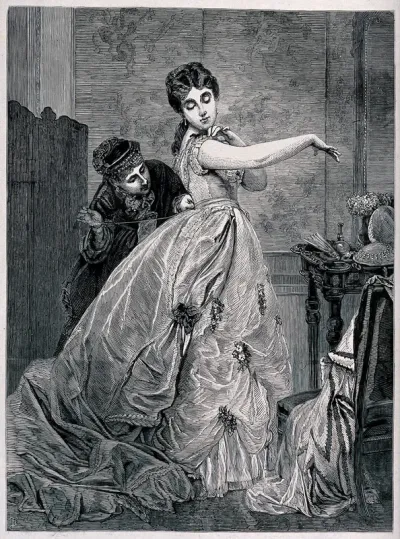 A girl is wearing a very elaborate gown which is being altered at the waist by a woman with a needle and thread