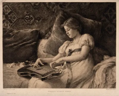 A girl leans against cushions on a sofa while playing a zither which she holds on her lap