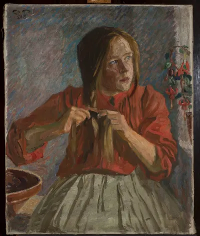 A girl plaiting her hair.