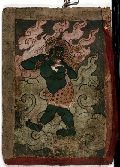 A green Tibetan demon (?) holding a skull cup and a vajra in its hand