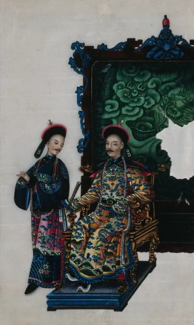 A high ranking Chinese official, seated on a double-headed dragon chair, with attendant, both dressed in richly patterned silks