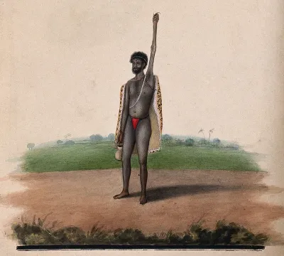 A Hindu ascetic or holy man: standing, with withered left arm raised over his head, and overgrown fingernails