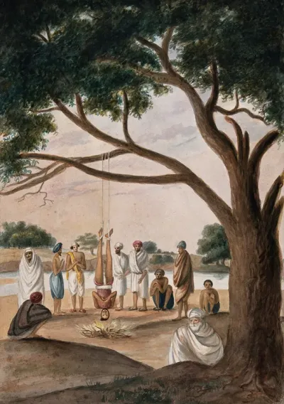 A Hindu ascetic or holy man: suspended upside down over a small fire by cords tied around his ankles
