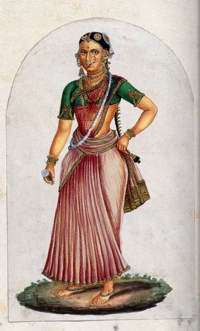 A Indian woman dancer, holding a flower in one hand