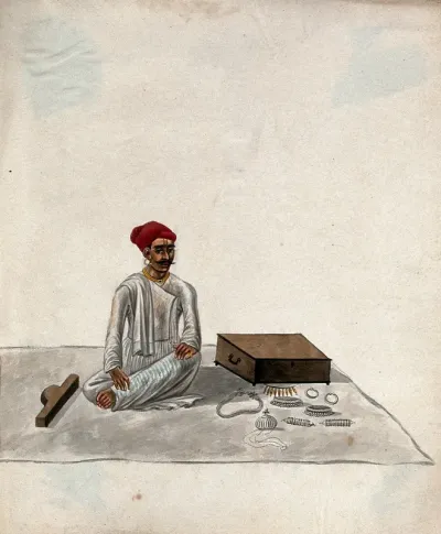 A jeweller displaying samples of his jewellery