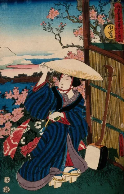 A kneeling woman in a broad straw hat, holding a pipe; a shamisen rests against the reed fence to the right; the view behind is a view of Fuji from Mukōjima