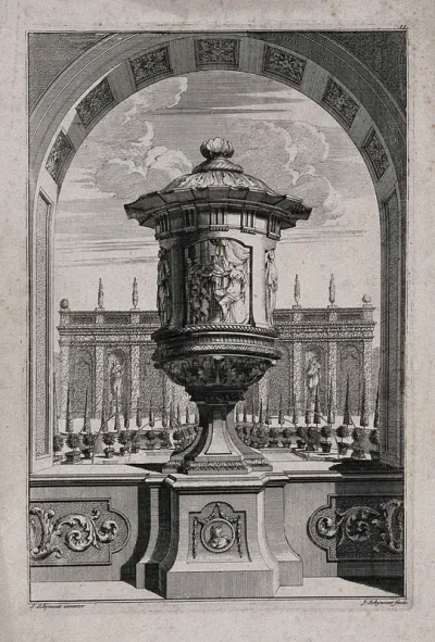 A large, ornate vase with figures partying carved in relief on the side, in a classical garden