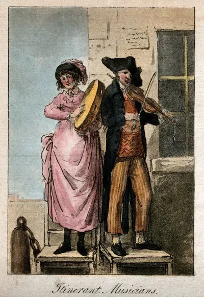 A man and a woman are standing on seats at the corner of a building, one is playing the tambourine and the other a violin