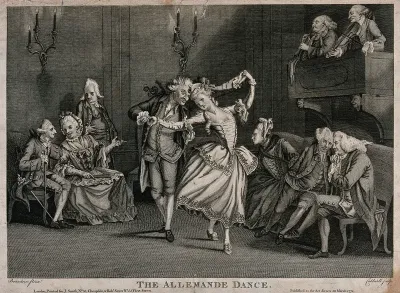 A man and a woman dancing watched by others sitting at the edges and talking
