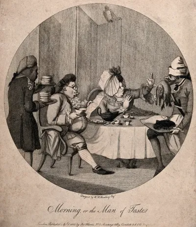 A man and a woman having a meal at the table as servants bring piles of food