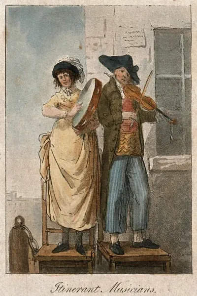 A man and a woman in France standing on chairs playing musical instruments in the street