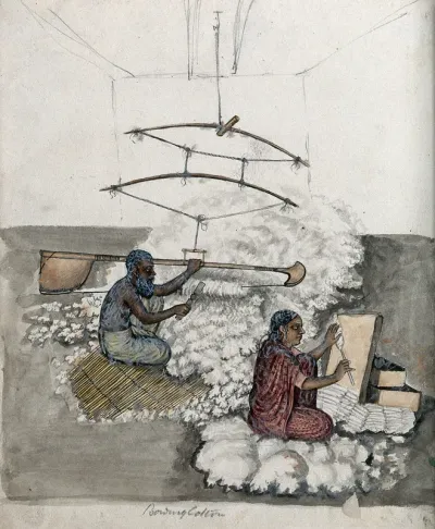 A man and a woman making cotton