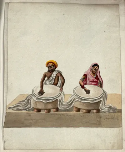 A man and a woman rubbing a piece of batik cloth (?)