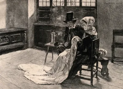 A man and a woman sit contentedly in their room, he is smoking a pipe while she sews