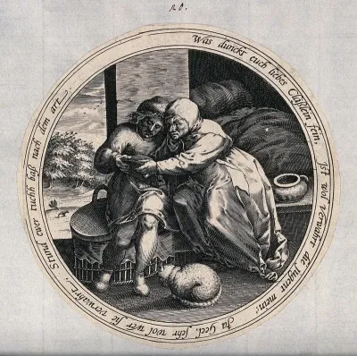 A man and a woman sit together holding a bowl