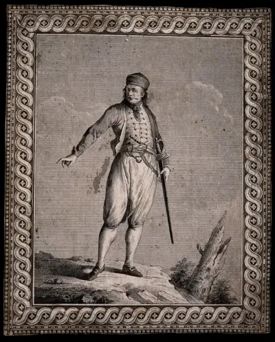 A man carrying a sword is standing on a rock