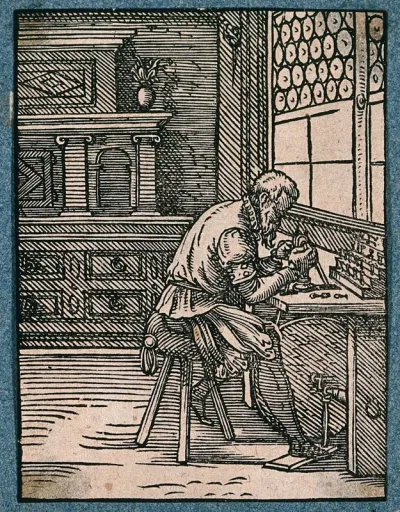 A man cutting gems using a treadle at his bench before a large window