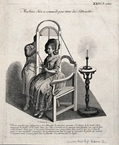 A man drawing the silhouette of a seated woman on translucent paper suspended in a frame and lit by a candle