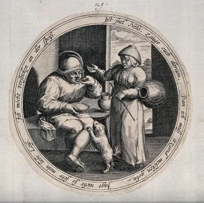 A man eats from a dish as the woman talks to him