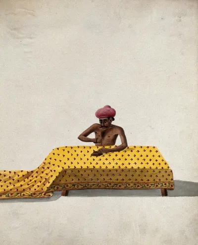 A man engaged in block printing a piece of cloth