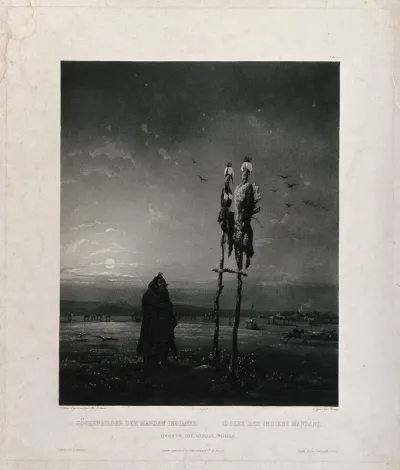A man from the Mandan tribe is looking up at two idols placed on wooden sticks; a village in the background