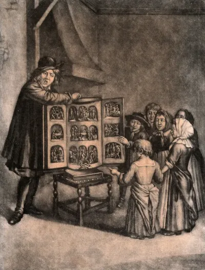 A man has an open box with figures in it resting on a chair, young children are crowding round to see the show