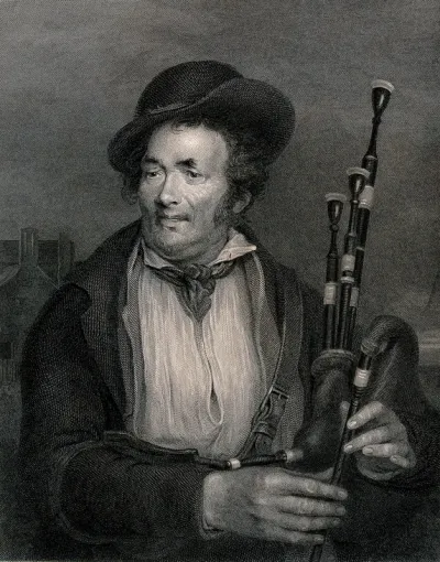 A man holding a set of bagpipes