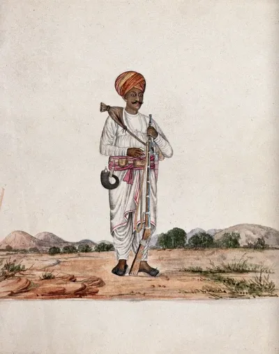 A man in the desert carrying a rifle in one hand and a water pouch over his shoulder