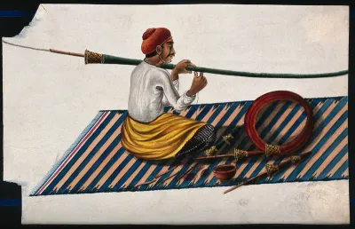 A man in the process of making or mending a hookah pipe