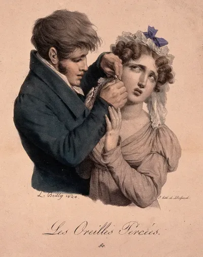 A man is piercing a girl's ear for an earring