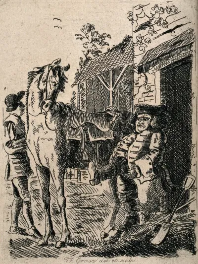 A man is pulling on a pair of riding boots at which the horse looks quizzically at him