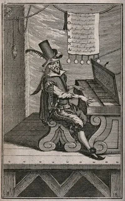 A man is sitting on a stage playing a keyboard instrument; a sheet of music and words is hanging from a line above his head