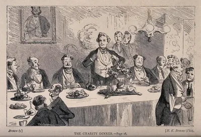 A man is standing to give a speech at a charity dinner