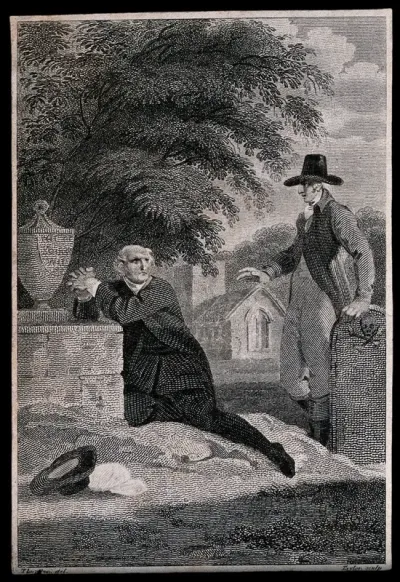 A man kneeling and praying at a tomb in a cemetery is joined by another gentleman