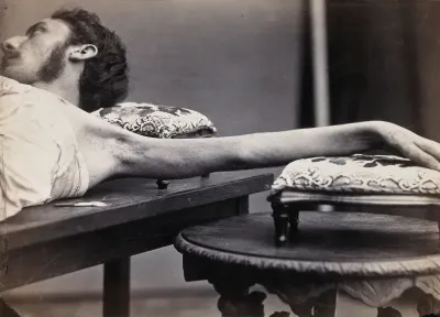 A man, lying down, his left arm outstretched