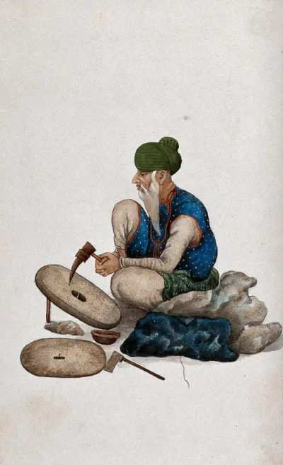 A man making grindstones