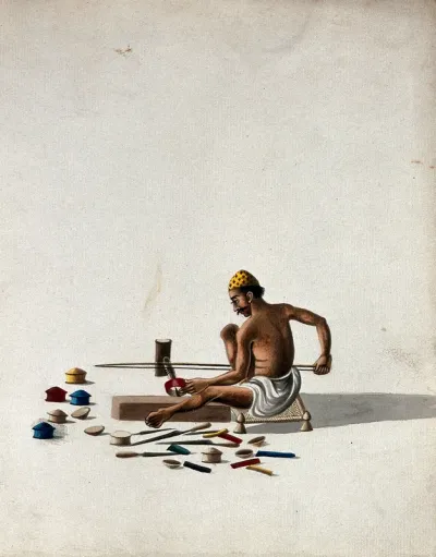 A man making small wooden objects (boxes)