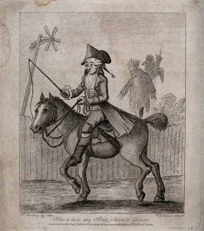 A man on horseback with a guiding rein and whip
