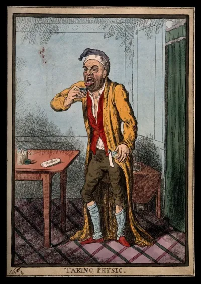 A man pulling a peculiar face as he is about to take some medicine