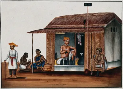 A man seated in a arrack shop pours a drink