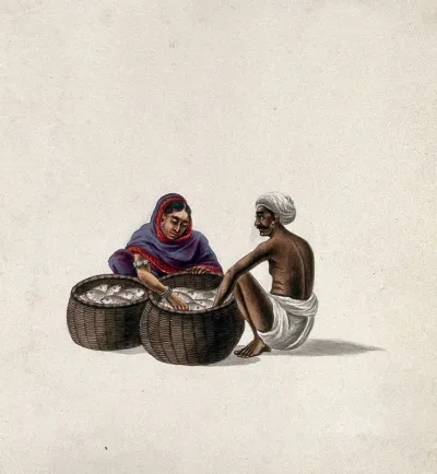 A man selling fish, displayed in two baskets, to a woman