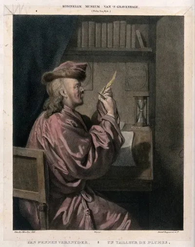 A man sits at a desk sharpening a quill pen with a knife