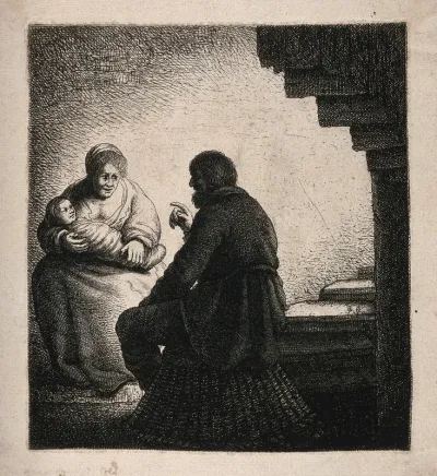 A man talking to a woman holding her baby