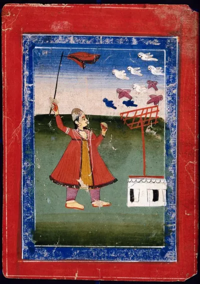 A man waving a stick to frighten the birds away