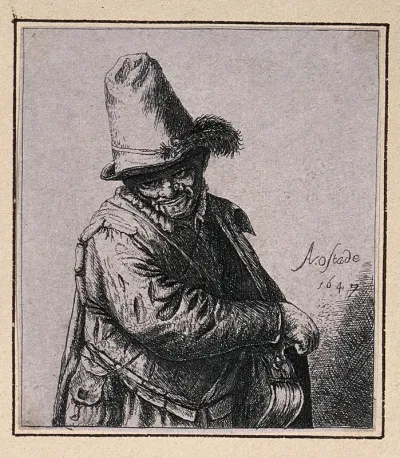 A man wearing a cap with a feather in it is playing a hurdygurdy