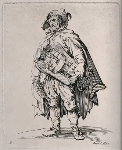 A man wearing a cloak and a wide-brimmed hat is carrying a hurdy-gurdy